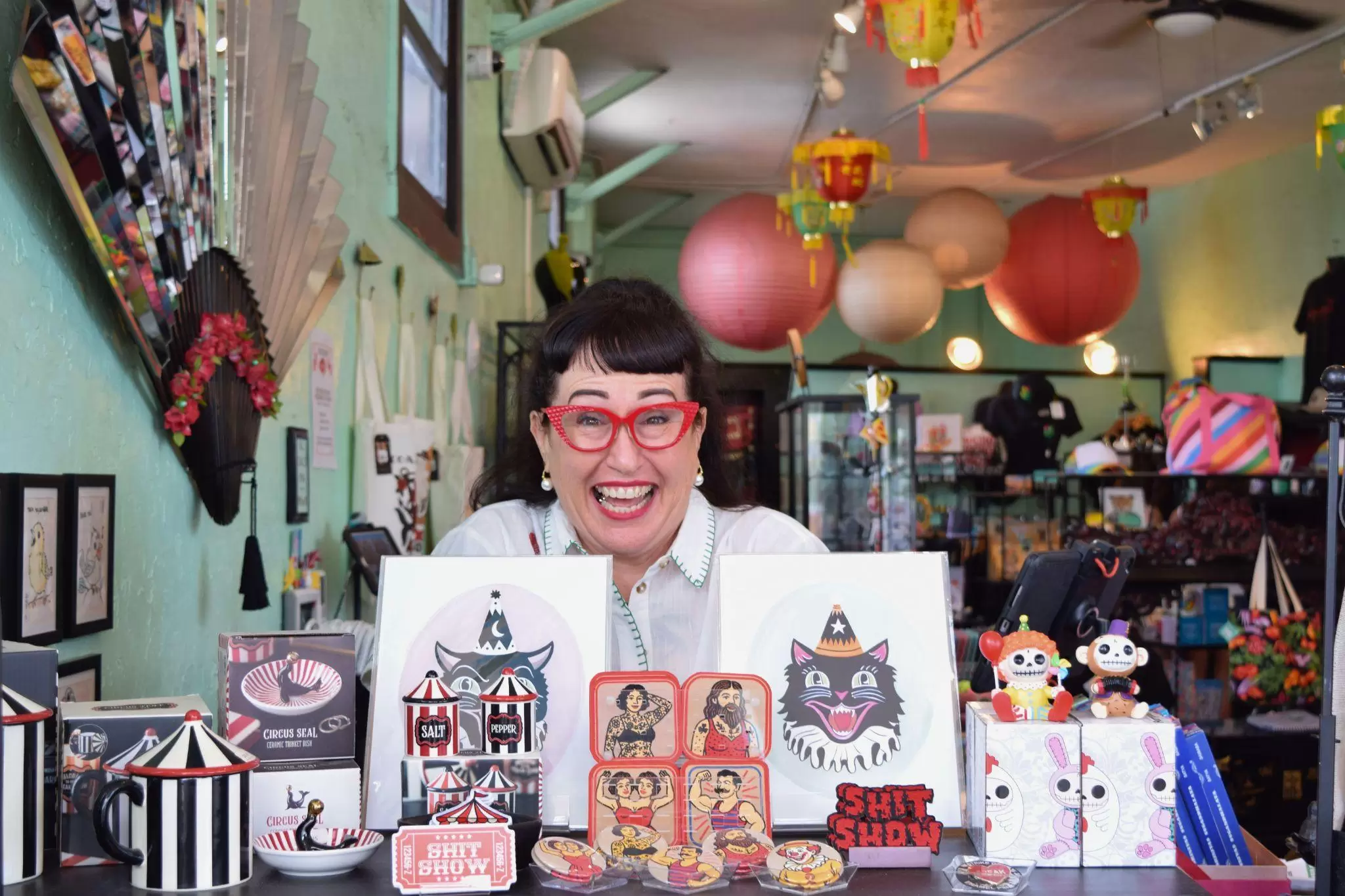 Songbird owner Jennifer Hill behind the register with the circus collection